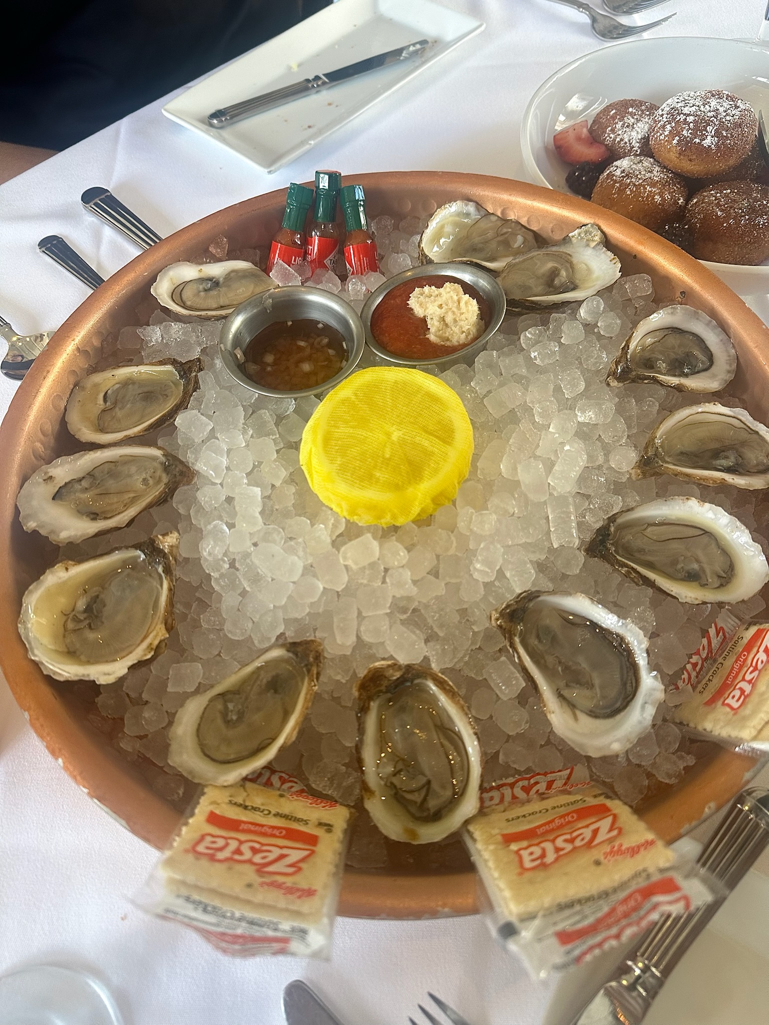 Oysters arranged in a circle around a lemon